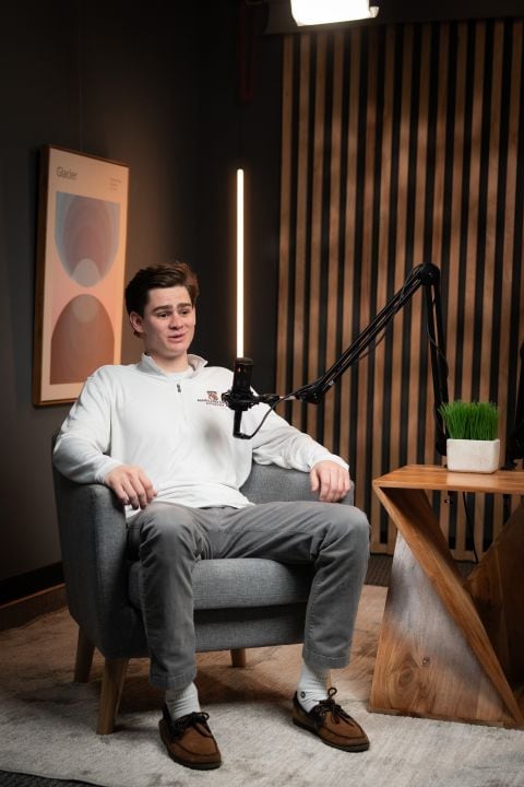 Conor Edwards on mic in the podcast studio